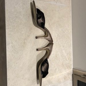 Black lace high heel slides.